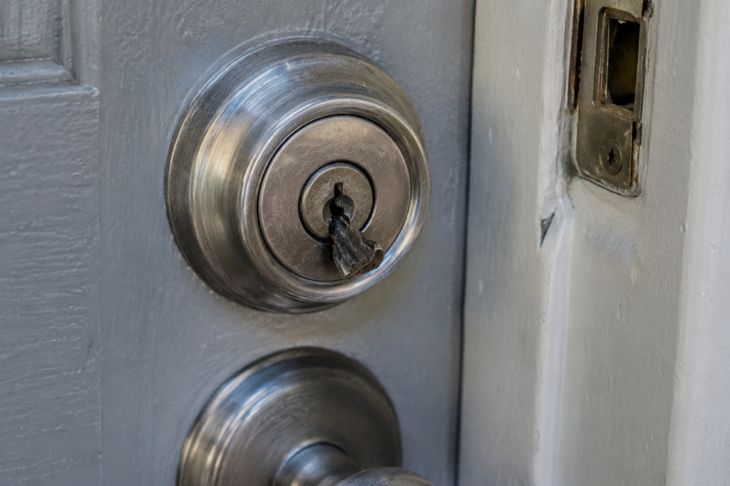 Professional locksmith inspecting a lock after broken key removal in Denver